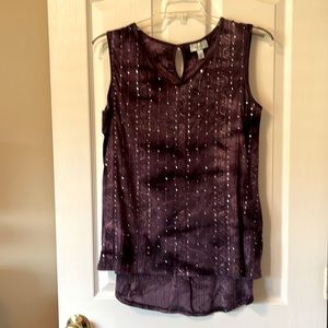 Ladies blouse. Sleeveless with mini, shiny disks sewn on.